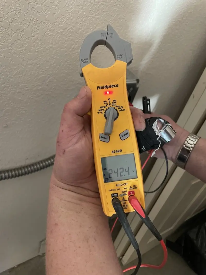 Voltage testing with clamp meter during Outlet Installation in Coral Hills